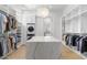 Open walk-in closet with large center island and ample storage at 19494 N 98Th Pl, Scottsdale, AZ 85255