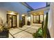 An outdoor courtyard with flagstone flooring, potted succulents, and multiple entrances into the home at 19494 N 98Th Pl, Scottsdale, AZ 85255