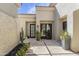 Courtyard boasts dual entrances, travertine floors, a water feature, and beautiful plants at 19494 N 98Th Pl, Scottsdale, AZ 85255