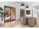 Bright dining area with seating for six, modern pendant lights, and a view to the outdoors through glass doors at 19494 N 98Th Pl, Scottsdale, AZ 85255