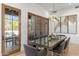 Dining area with seating for ten, stylish light fixture, and views to outdoor living at 19494 N 98Th Pl, Scottsdale, AZ 85255