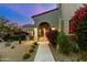 Inviting front entrance with manicured landscaping, stone walkway, and architectural lighting, showcasing curb appeal at 19494 N 98Th Pl, Scottsdale, AZ 85255