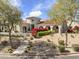 Well-maintained home with desert landscaping, mature trees, and a red-tiled roof at 19494 N 98Th Pl, Scottsdale, AZ 85255