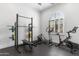 Home gym featuring ample workout machines, weights and an arched window letting in light at 19494 N 98Th Pl, Scottsdale, AZ 85255