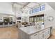 Open-concept space with wood floors and chef's kitchen, flowing into the living room at 19494 N 98Th Pl, Scottsdale, AZ 85255