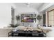Open concept living room with a comfortable sofa, stylish console table, and custom built-ins for storage at 19494 N 98Th Pl, Scottsdale, AZ 85255