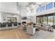 Spacious living room with fireplace, wood floors, and designer furnishings at 19494 N 98Th Pl, Scottsdale, AZ 85255
