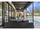 Inviting outdoor living space featuring a porch swing, pool and plush lounge seating for relaxation and entertainment at 19494 N 98Th Pl, Scottsdale, AZ 85255