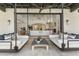 Covered patio with hanging swing beds, a ceiling fan, and an open view into the home's living room at 19494 N 98Th Pl, Scottsdale, AZ 85255