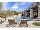 Beautiful backyard pool with stone accents and lounge chairs, ideal for relaxation and outdoor enjoyment at 19494 N 98Th Pl, Scottsdale, AZ 85255