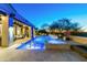An in-ground pool with in-water seating, a raised hot tub, and an outdoor seating area at 19494 N 98Th Pl, Scottsdale, AZ 85255