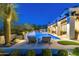 Inviting backyard pool and spa area with water feature, lounge chairs, desert landscape and mountain views at 19494 N 98Th Pl, Scottsdale, AZ 85255
