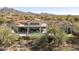 Aerial view of a luxurious backyard with a pool, covered patio, and stunning mountain views at 19494 N 98Th Pl, Scottsdale, AZ 85255