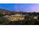 An aerial rear exterior view of the property with mountain views, outdoor patio furniture and a terracotta tiled roof at 19494 N 98Th Pl, Scottsdale, AZ 85255