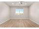 Bright bedroom featuring wood-look tile flooring, neutral walls, and a window with exterior views at 19496 E Erik Ct, Florence, AZ 85132