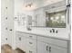 Bathroom featuring double sinks, a large mirror and a view into the walk-in shower at 20624 S 216Th Pl, Queen Creek, AZ 85142