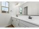 Bright bathroom with double sinks, white cabinetry, and modern fixtures at 20624 S 216Th Pl, Queen Creek, AZ 85142