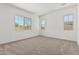 Bright carpeted bedroom with multiple windows, offering great natural light at 20624 S 216Th Pl, Queen Creek, AZ 85142