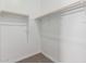 Bright walk-in closet with ample shelving and neutral carpeting at 20624 S 216Th Pl, Queen Creek, AZ 85142