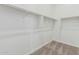 Spacious walk-in closet with ample shelving and neutral carpeting at 20624 S 216Th Pl, Queen Creek, AZ 85142
