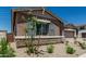 Charming home exterior with stone accents, gray shutters, and desert landscaping for a low-maintenance yard at 20624 S 216Th Pl, Queen Creek, AZ 85142
