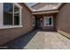 Home's front entrance featuring a stone walkway, gravel landscaping, and a gray front door at 20624 S 216Th Pl, Queen Creek, AZ 85142