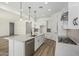 Bright kitchen with a spacious island, stainless steel appliances, and stylish pendant lighting at 20624 S 216Th Pl, Queen Creek, AZ 85142
