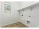 Bright laundry room with overhead shelving and tile flooring at 20624 S 216Th Pl, Queen Creek, AZ 85142