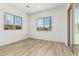 Bright living room featuring stylish flooring, a sliding glass door, and multiple windows at 20624 S 216Th Pl, Queen Creek, AZ 85142
