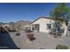 Wide view of backyard features gravel groundcover, desert landscaping and mountain views at 21427 W Monte Vista Rd, Buckeye, AZ 85396