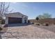 Exterior of home showcasing landscaped front yard, brick driveway, and attached garage at 21427 W Monte Vista Rd, Buckeye, AZ 85396