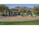 Community playground featuring swings, play equipment, and shaded picnic area with mountain views in the background at 21427 W Monte Vista Rd, Buckeye, AZ 85396