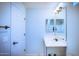 Clean bathroom featuring a modern sink, a white door, and bright lighting at 2315 N 52Nd St # 104, Phoenix, AZ 85008