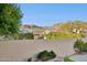 View of the desert landscape from the backyard, enclosed by a stucco wall at 2318 E Granite View Dr, Phoenix, AZ 85048