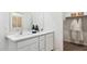 Bright bathroom featuring dual sinks, a large mirror, and ample storage space at 23997 W Cocopah St, Buckeye, AZ 85326