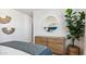 Bright bedroom featuring a dresser and large potted plant at 23997 W Cocopah St, Buckeye, AZ 85326