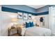 Nicely decorated bedroom with striped walls and natural wood furniture at 23997 W Cocopah St, Buckeye, AZ 85326