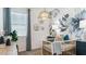 Charming Bedroom featuring a stylish crib, accent wall with floral design, and a cozy woven pendant light at 23997 W Cocopah St, Buckeye, AZ 85326