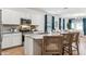 Bright kitchen featuring white cabinetry, stainless steel appliances, granite countertops, and a center island at 23997 W Cocopah St, Buckeye, AZ 85326