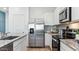 Modern kitchen with stainless steel appliances, granite countertops and a stainless steel refrigerator at 23997 W Cocopah St, Buckeye, AZ 85326