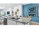 Kitchen island with a sink and stainless steel dishwasher, and stylish wall decor at 23997 W Cocopah St, Buckeye, AZ 85326