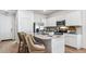 Bright kitchen featuring white cabinets, granite countertops, stainless steel appliances, and island seating at 23997 W Cocopah St, Buckeye, AZ 85326