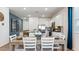 Bright kitchen and dining area featuring stainless appliances and a light wood dining table at 23997 W Cocopah St, Buckeye, AZ 85326
