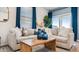 Comfortable living room with a large sectional sofa, wood coffee table, and bright natural light at 23997 W Cocopah St, Buckeye, AZ 85326