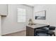 Cozy home office space with a large desk, modern chairs and a view from the window at 23997 W Cocopah St, Buckeye, AZ 85326
