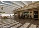 Spacious covered patio with shade structure and comfortable seating arrangement at 2506 S Acanthus --, Mesa, AZ 85209