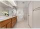 Bright bathroom featuring double sinks, oak cabinetry, soaking tub and glass shower at 2506 S Acanthus --, Mesa, AZ 85209
