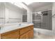 Bathroom vanity features a large mirror and a shower with glass doors at 2506 S Acanthus --, Mesa, AZ 85209