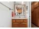 Cozy bathroom with oak cabinets, a mirror, and soft lighting at 2506 S Acanthus --, Mesa, AZ 85209