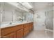 Bright bathroom featuring double sinks, oak cabinetry, soaking tub and glass shower at 2506 S Acanthus --, Mesa, AZ 85209
